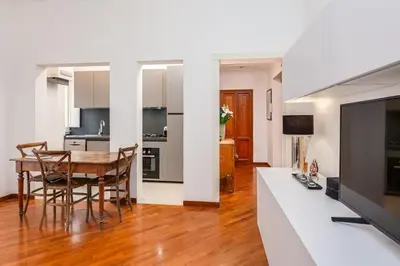 a kitchen and dining room with a table and chairs at S. Cosimato Trastevere in Rome