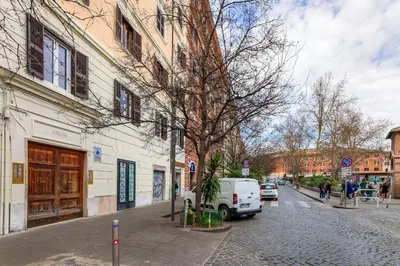a white van parked on a street next to a building at S. Cosimato Trastevere in Rome