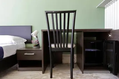 a chair sitting next to a desk and a bed at Lucky Stars rooms in Rome