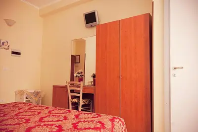 a bedroom with a bed and a cabinet and a desk at Parioli House in Rome