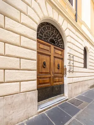 a wooden door on the side of a building at House Montebello in Rome