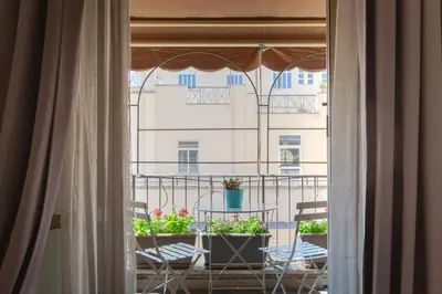 a balcony with two chairs and a table with plants at Residenza Il Duca in Rome