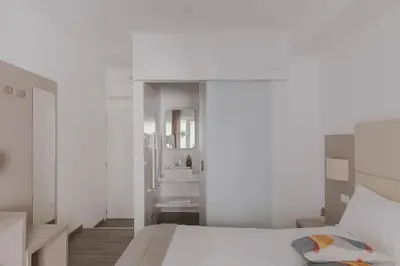 a white bedroom with a bed and a sink at Residenza Il Duca in Rome
