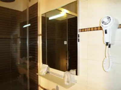 a shower in a bathroom with a mirror at Manila Inn in Rome