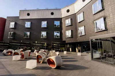 a building with a bunch of chairs in front of it at Black Hotel in Rome