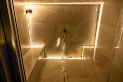 a bathroom with a shower with a light in it at Black Hotel in Rome