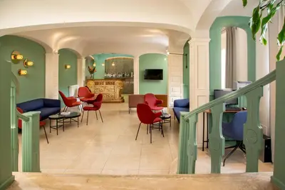 a living room with chairs and a staircase at Hotel Colosseum in Rome