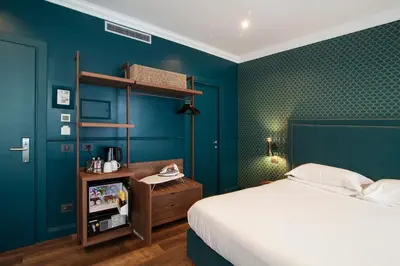 a bedroom with a bed and a blue wall at Seven Suites in Rome