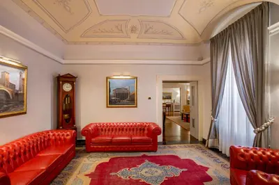 a living room with red leather furniture and a ceiling at La Residenza in Rome
