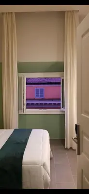 a bedroom with a bed and a window with a view at New Morpheus Rooms in Rome
