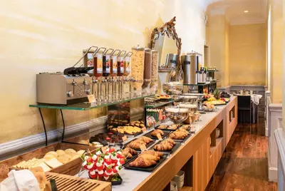 a buffet line with various pastries and other foods at Alpi Hotel in Rome