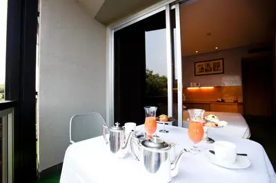 a white table with two tables with drinks on it at Albani Hotel Roma in Rome