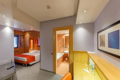 a hotel room with a bed and a bathroom at Albani Hotel Roma in Rome