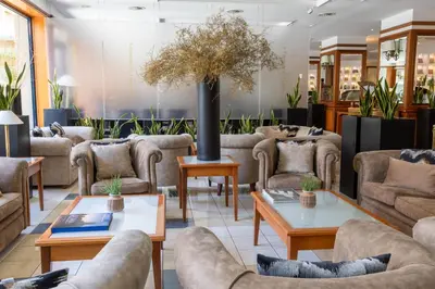 a waiting room with couches and tables at Grand Hotel Tiberio in Rome