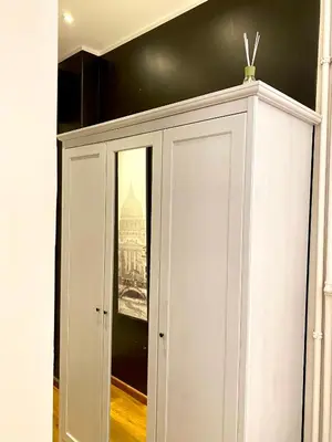 a white cabinet with a picture on the wall at Roome B&B in Rome