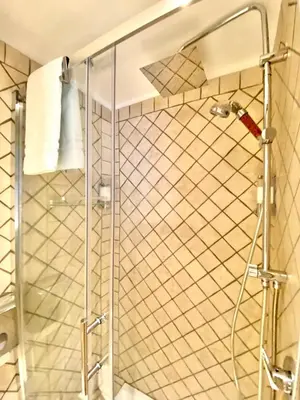 a shower with a glass door in a bathroom at Roome B&B in Rome