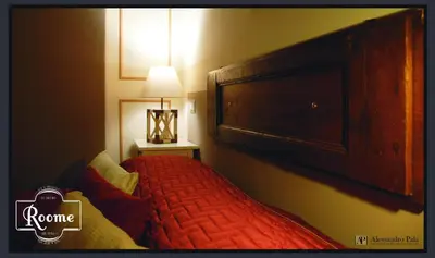 a bedroom with a large bed with a large headboard at Roome B&B in Rome