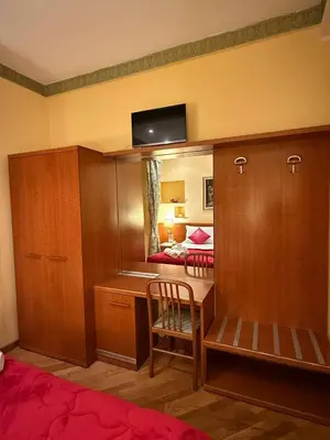 a room with a desk and a bedroom with a bed at Hotel Fenicia in Rome