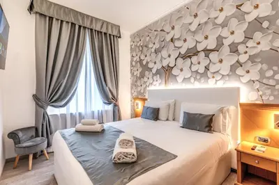 a bedroom with a large bed and a chair at Roma dei Papi B&B in Rome