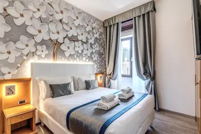 a bedroom with a bed with two towels on it at Roma dei Papi B&B in Rome