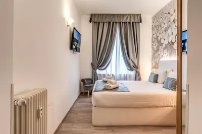 a hotel room with a bed and a window at Roma dei Papi B&B in Rome