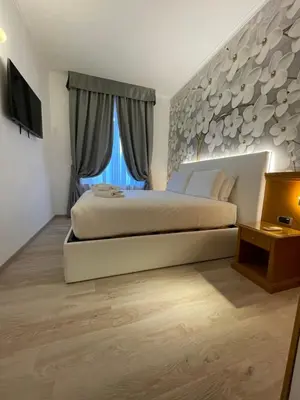 a bedroom with a large bed and a large window at Roma dei Papi B&B in Rome