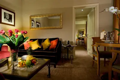 a living room with a couch and a table with flowers at Hotel dei Mellini in Rome