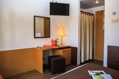 a hotel room with a desk and a mirror at Hotel Sisto V in Rome