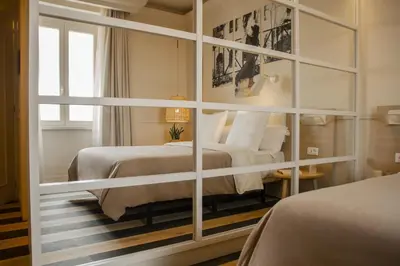 a bedroom with two beds and a large mirror at room Select Via Veneto in Rome