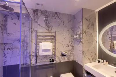 a purple bathroom with a shower and a sink at Hotel Diana Roof Garden in Rome