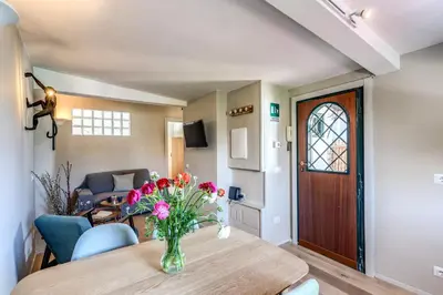 a dining room with a table with flowers on it at RR Apartments San Giovanni in Rome