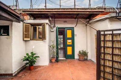 a house with a green and yellow door at RR Apartments San Giovanni in Rome