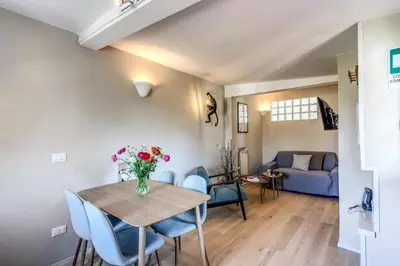 a dining room and living room with a table and chairs at RR Apartments San Giovanni in Rome