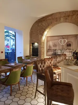 a restaurant with a bar with chairs and tables at Hotel Milton Roma in Rome