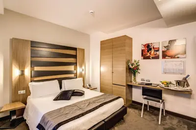 a hotel room with a bed and a desk at Hotel Trevi - Gruppo Trevi Hotels in Rome