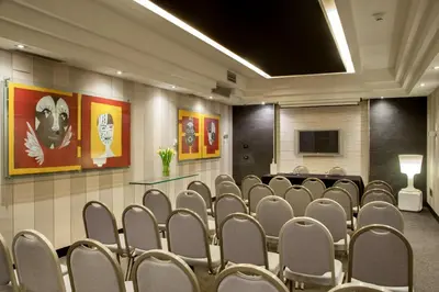 a conference room with chairs and a tv in it at Hotel Ariston in Rome