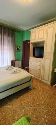a bedroom with a bed and a dresser with a tv at Er Centurione in Rome