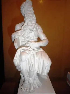 a white statue sitting on top of a table at Buonarroti Home in Rome