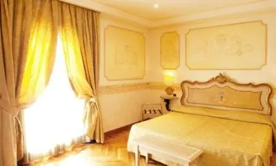 a bedroom with a bed and a large window at Hotel Villa San Pio in Rome