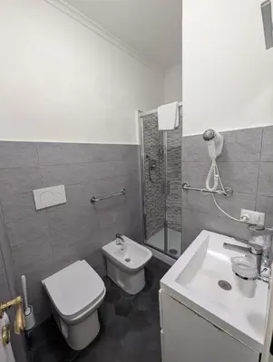 a bathroom with a toilet and a sink and a shower at Residenza Ki in Rome
