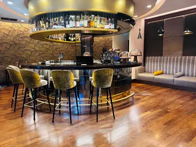 a bar in a restaurant with chairs and a bar counter at Crowne Plaza Rome St. Peter's by IHG in Rome