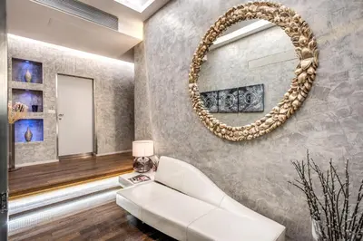 a living room with a white couch and a mirror at Roma Boutique Hotel in Rome
