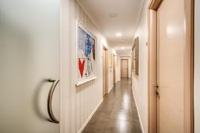 a corridor of a hallway with paintings on the walls at Roma Boutique Hotel in Rome