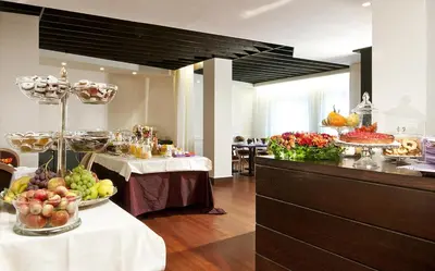 a buffet line with fruits and vegetables in a room at Hotel Fenix in Rome