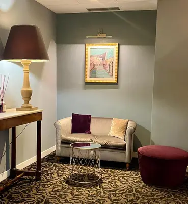 a living room with a couch and a table at Hotel Fenix in Rome