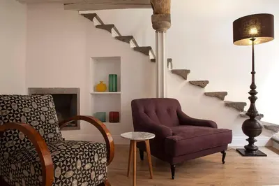 a living room with a chair and a lamp at Casa Fabbrini Boutique B&B in Rome