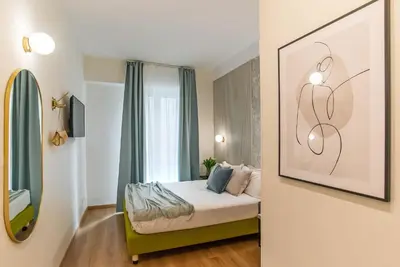 a bedroom with a bed and a picture on the wall at 94Rooms Vatican Guest House- Scipioni in Rome