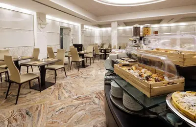 a restaurant with tables and chairs and a buffet at Best Western Plus Hotel Universo in Rome