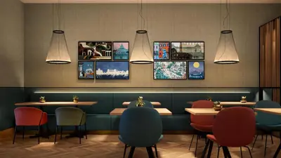 a restaurant with tables and chairs and pictures on the wall at Hilton Garden Inn Rome Colosseum in Rome