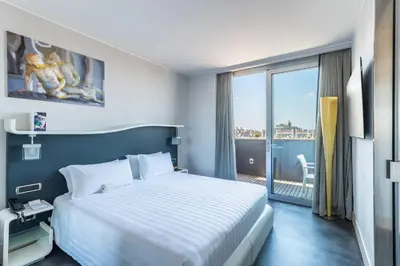 a hotel room with a bed and a large window at Best Western Premier Hotel Royal Santina in Rome